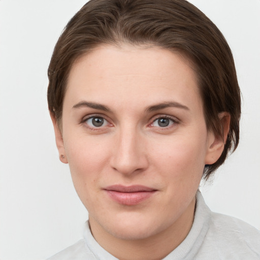 Joyful white young-adult female with short  brown hair and grey eyes