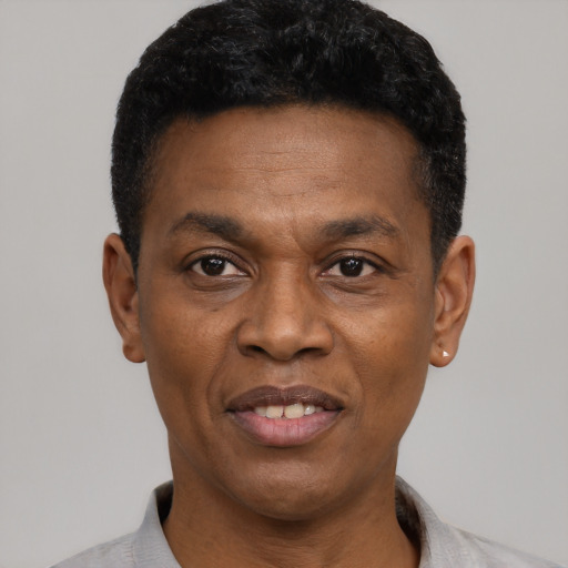 Joyful black adult male with short  black hair and brown eyes