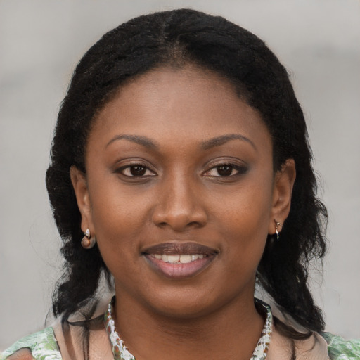 Joyful black young-adult female with medium  brown hair and brown eyes