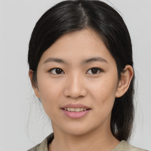 Joyful asian young-adult female with medium  black hair and brown eyes