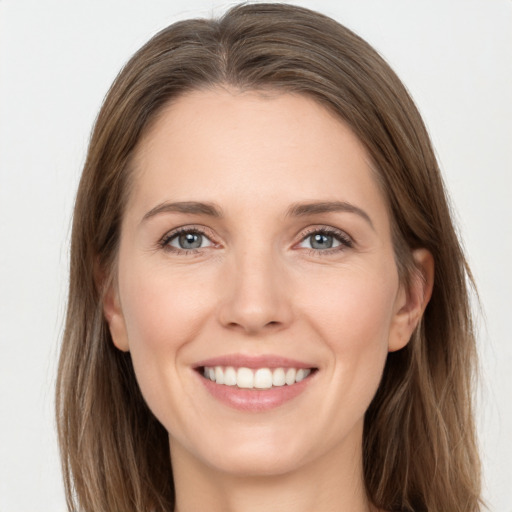 Joyful white young-adult female with long  brown hair and grey eyes