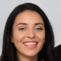 Joyful white young-adult female with long  black hair and brown eyes