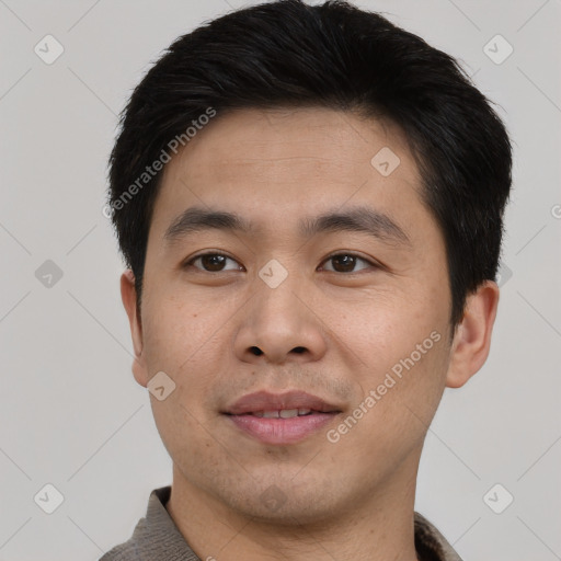 Joyful asian young-adult male with short  black hair and brown eyes