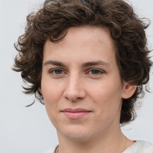 Joyful white young-adult female with medium  brown hair and green eyes