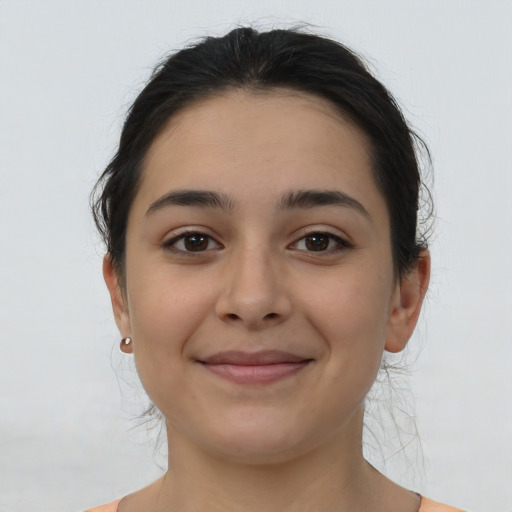 Joyful latino young-adult female with medium  brown hair and brown eyes