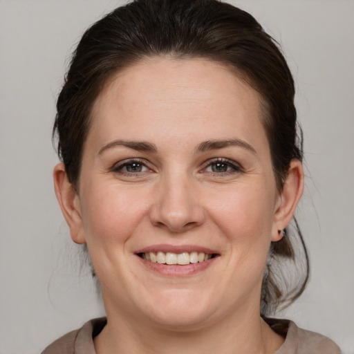 Joyful white adult female with medium  brown hair and brown eyes