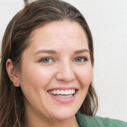 Joyful white young-adult female with long  brown hair and green eyes