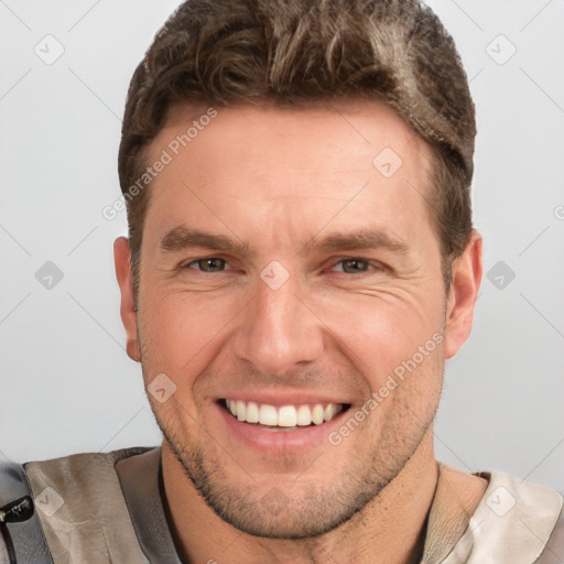 Joyful white adult male with short  brown hair and grey eyes