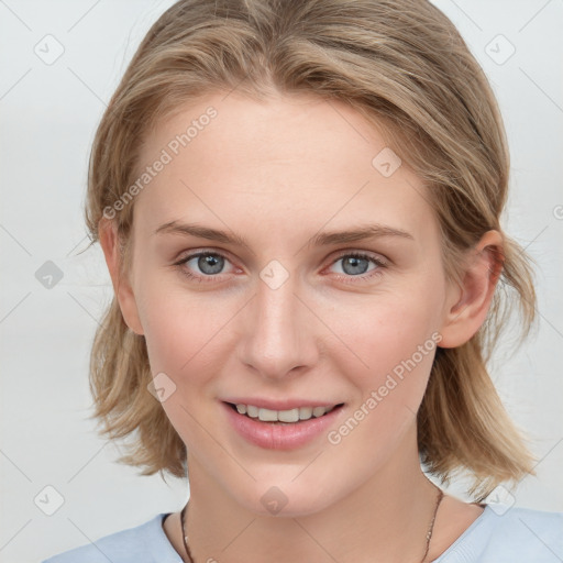 Joyful white young-adult female with medium  brown hair and blue eyes