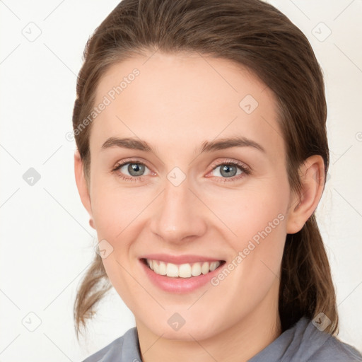 Joyful white young-adult female with medium  brown hair and grey eyes