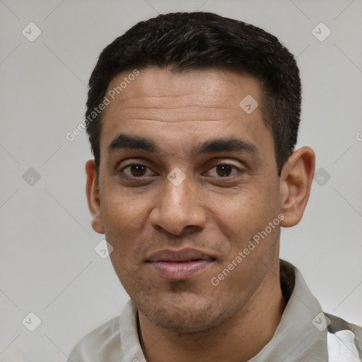 Joyful white young-adult male with short  black hair and brown eyes