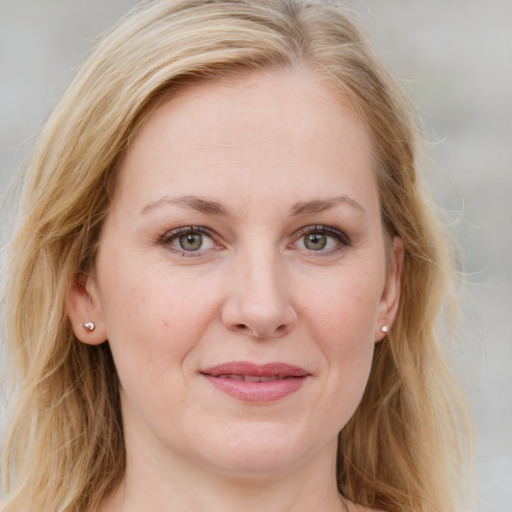 Joyful white young-adult female with long  brown hair and blue eyes