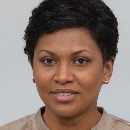 Joyful black young-adult female with short  brown hair and brown eyes