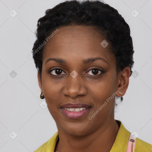 Joyful black young-adult female with short  black hair and brown eyes