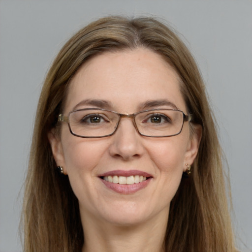 Joyful white adult female with long  brown hair and grey eyes