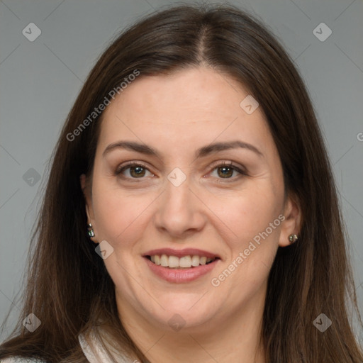 Joyful white adult female with long  brown hair and brown eyes