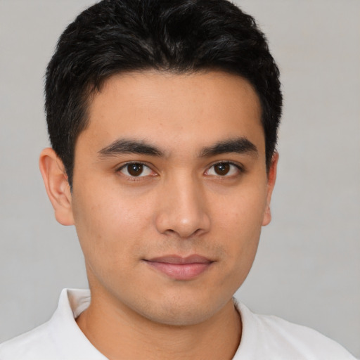 Joyful latino young-adult male with short  black hair and brown eyes