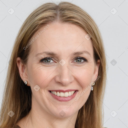 Joyful white adult female with long  brown hair and blue eyes