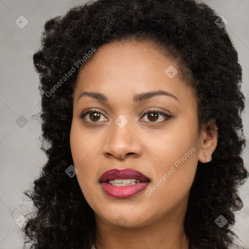 Joyful black young-adult female with long  black hair and brown eyes