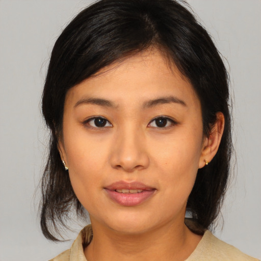 Joyful asian young-adult female with medium  brown hair and brown eyes