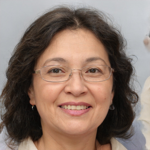 Joyful white middle-aged female with medium  brown hair and brown eyes