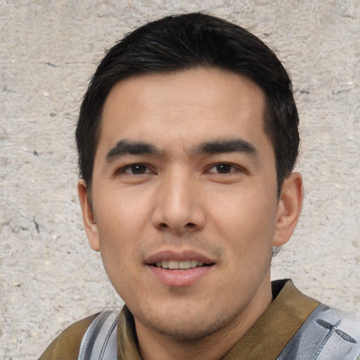Joyful asian young-adult male with short  black hair and brown eyes