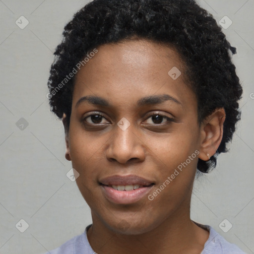 Joyful black young-adult female with short  black hair and brown eyes