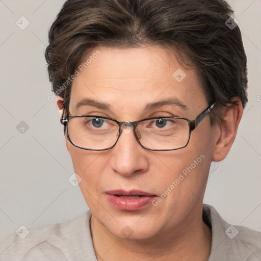 Joyful white adult female with short  brown hair and brown eyes