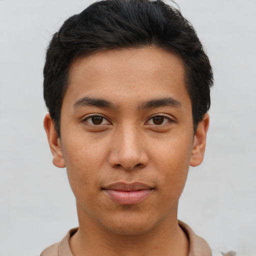 Joyful asian young-adult male with short  brown hair and brown eyes