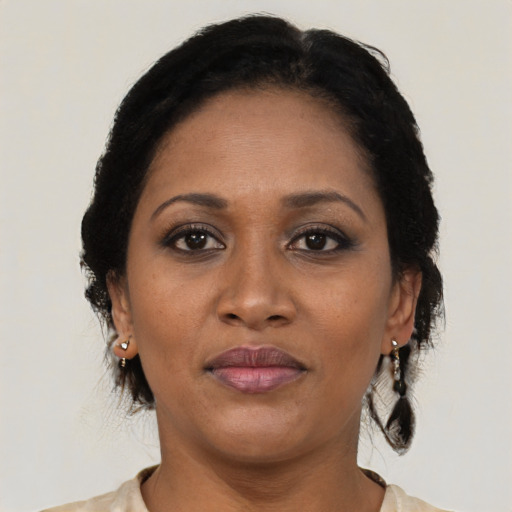 Joyful black adult female with medium  brown hair and brown eyes