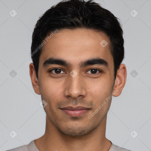 Joyful latino young-adult male with short  black hair and brown eyes