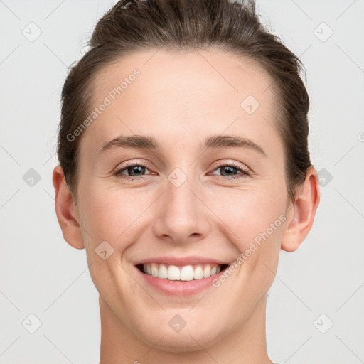 Joyful white young-adult female with short  brown hair and grey eyes