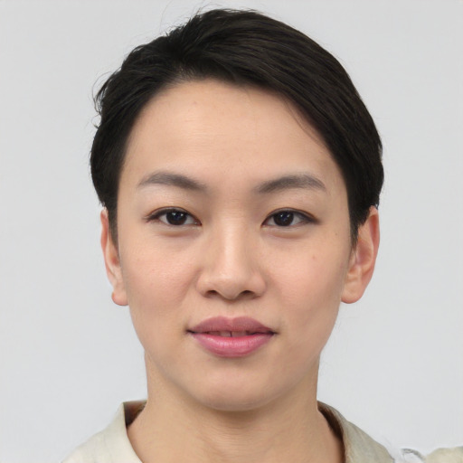 Joyful asian young-adult female with short  black hair and brown eyes