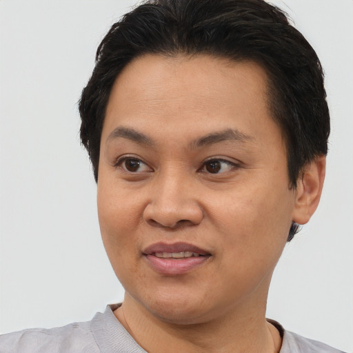 Joyful asian young-adult female with short  black hair and brown eyes