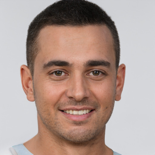 Joyful white young-adult male with short  brown hair and brown eyes