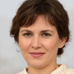 Joyful white adult female with medium  brown hair and brown eyes