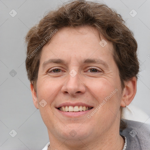 Joyful white adult male with short  brown hair and grey eyes