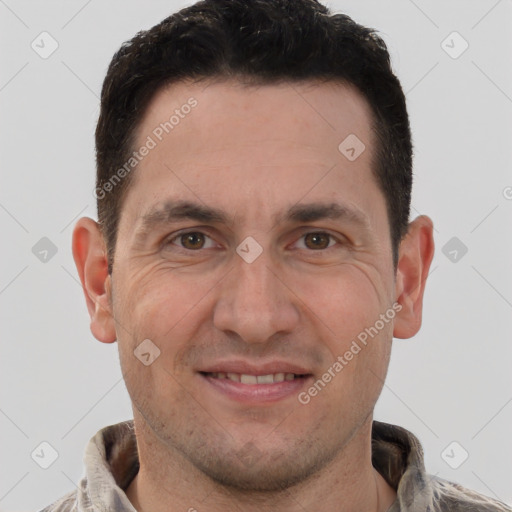 Joyful white adult male with short  brown hair and brown eyes