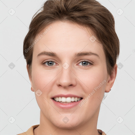 Joyful white young-adult female with short  brown hair and grey eyes