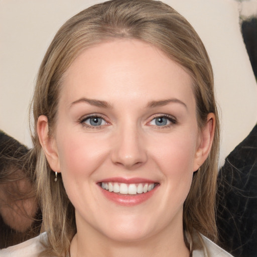 Joyful white young-adult female with medium  brown hair and grey eyes