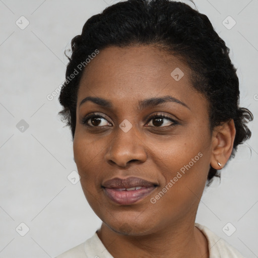 Joyful black young-adult female with short  black hair and brown eyes