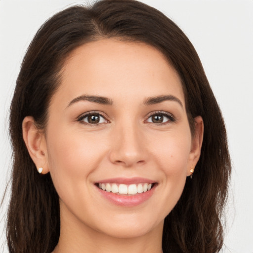 Joyful white young-adult female with long  brown hair and brown eyes