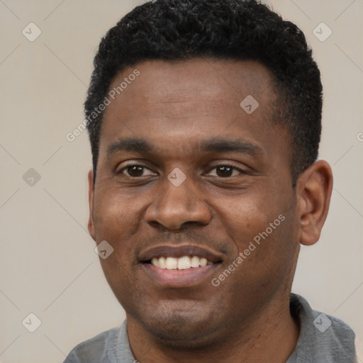 Joyful black young-adult male with short  black hair and brown eyes