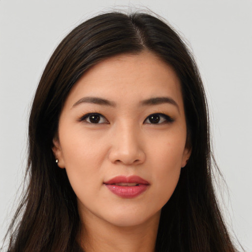 Joyful asian young-adult female with long  brown hair and brown eyes