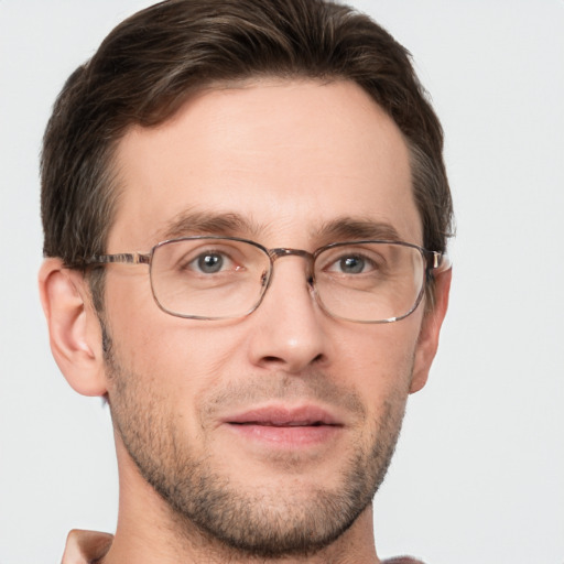 Joyful white adult male with short  brown hair and grey eyes