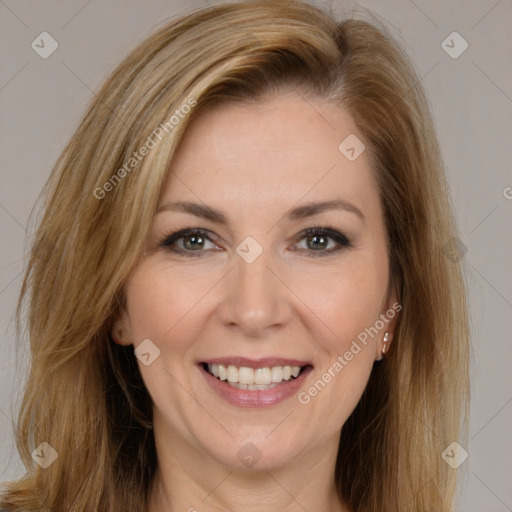 Joyful white adult female with long  brown hair and brown eyes