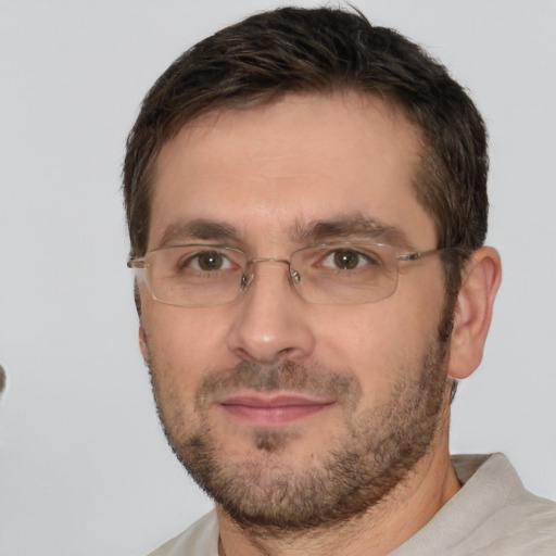 Joyful white adult male with short  brown hair and brown eyes