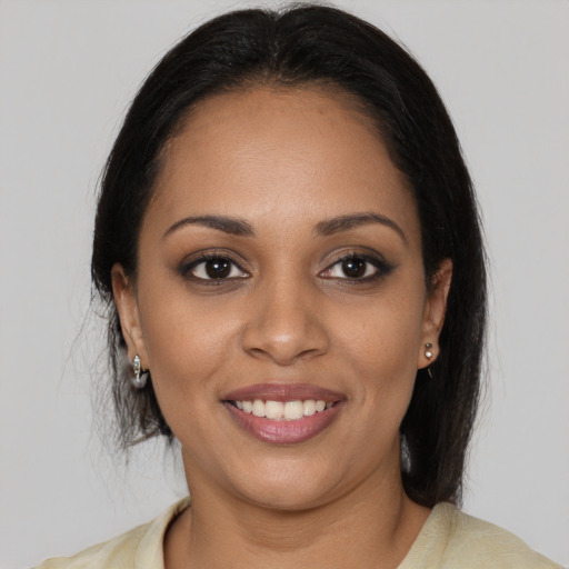 Joyful black young-adult female with medium  brown hair and brown eyes