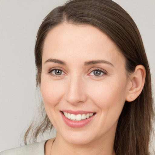 Joyful white young-adult female with long  brown hair and grey eyes