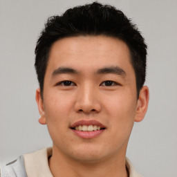 Joyful asian young-adult male with short  black hair and brown eyes